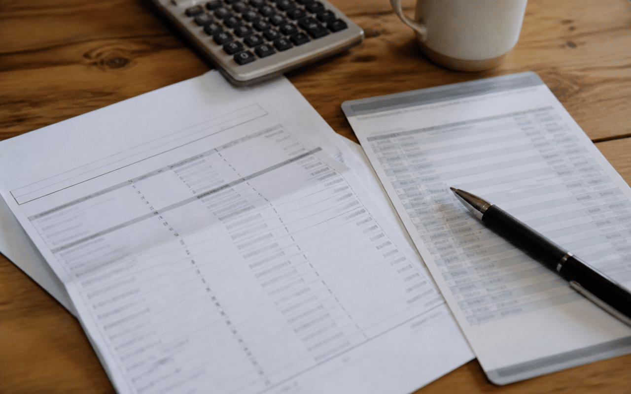 Document officiel avec chiffres, stylo et relevé bancaire.