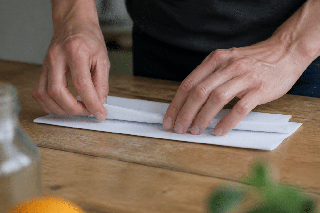 Mains pliant documents blancs sur table de travail